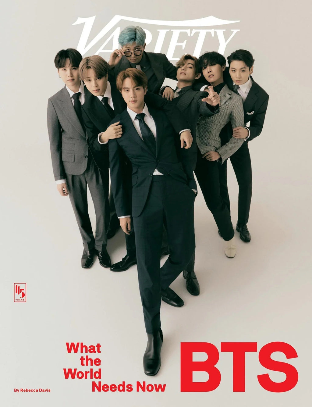 BTS poster featuring all members in stylish suits posing together in a clean studio setting, with bold red typography and a modern magazine-style design