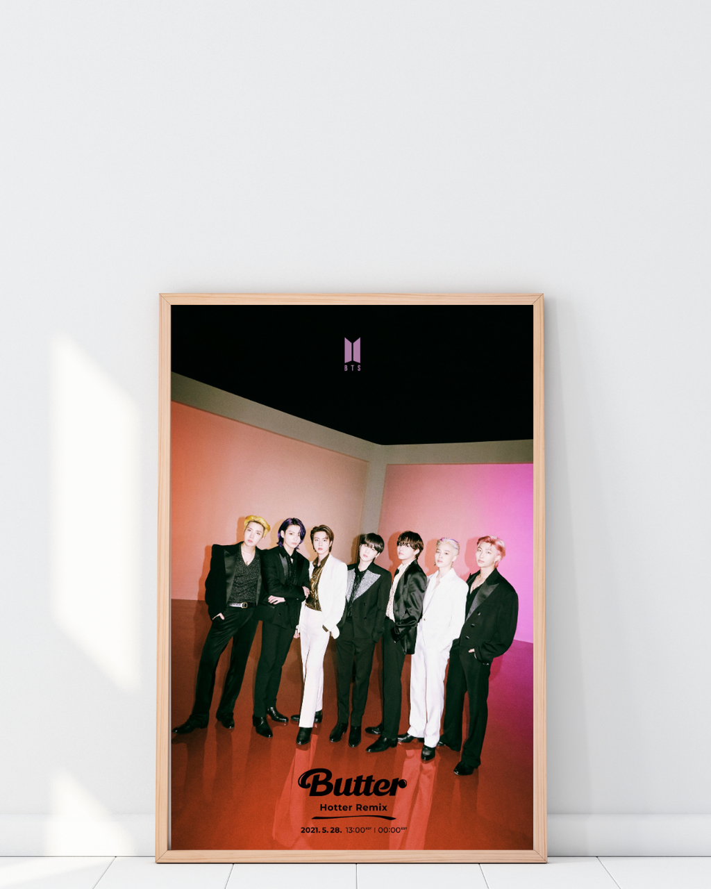 Framed BTS Butter Hotter Remix poster displayed in a modern room, highlighting a bold K-pop aesthetic with vibrant colors and stylish group visuals.