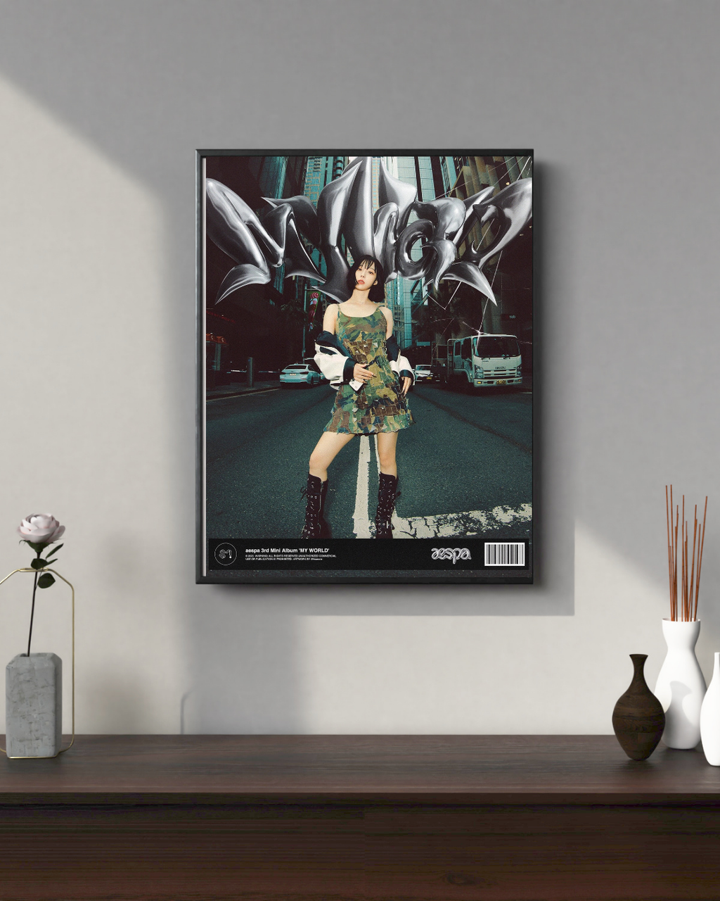 aespa My World solo poster with member standing in city street wearing camo dress and boots with metallic text behind.